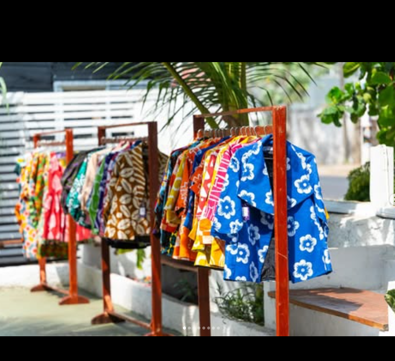 A colourful collection of Rhophys Couture blazers displayed outdoors